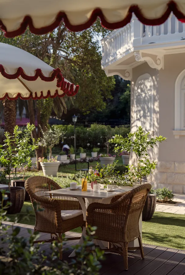 Garden dining table set under a scalloped parasol