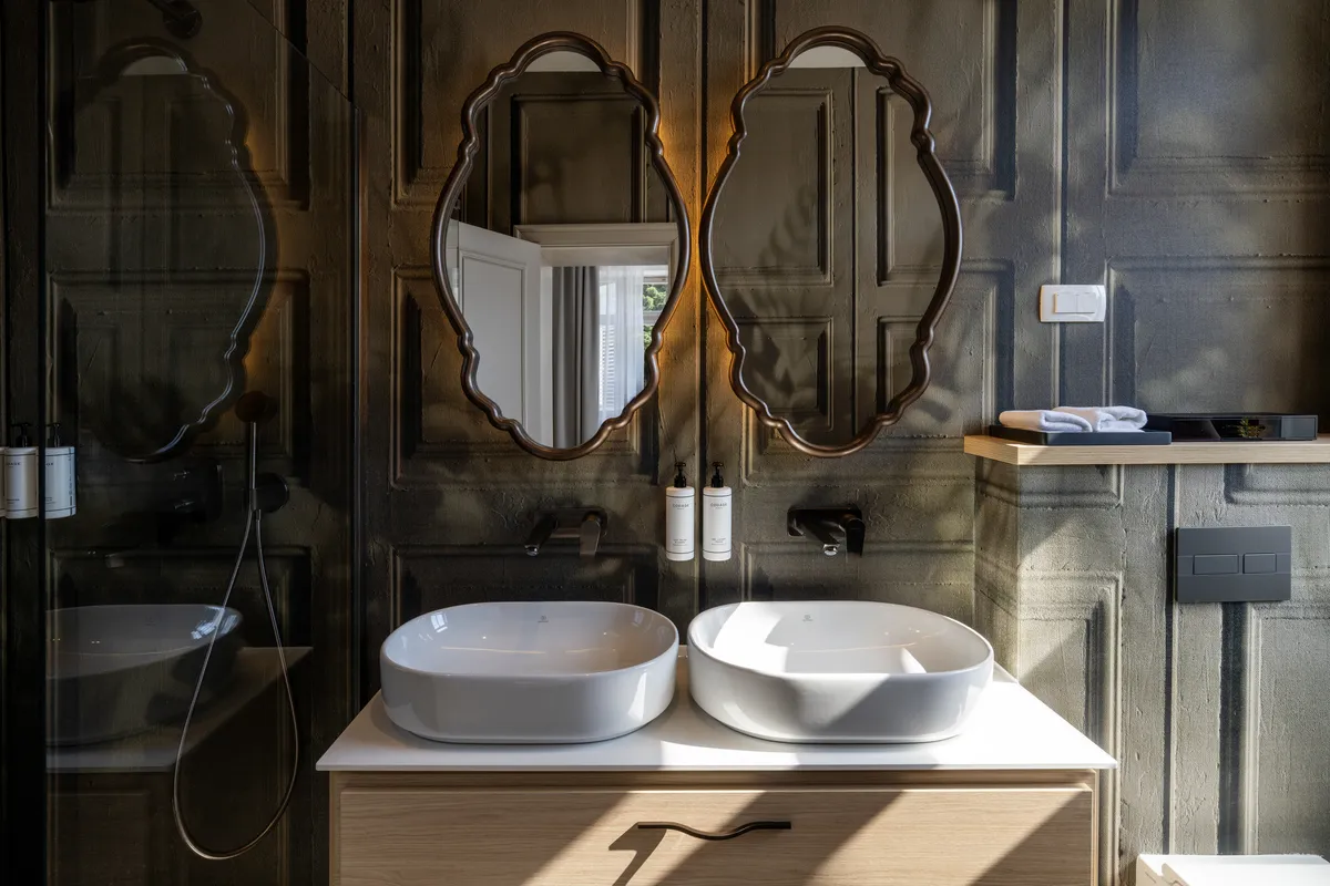 Suite bathroom with stone finish and soft lighting